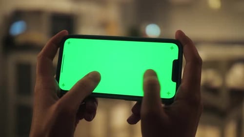 Close Up Shot of Person Playing Video Games on Smartphone with Chroma Key Green Screen