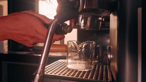 Barista Installing Portafilter before New Espresso Attempt in Slow Motion, Close View of Empty Glass