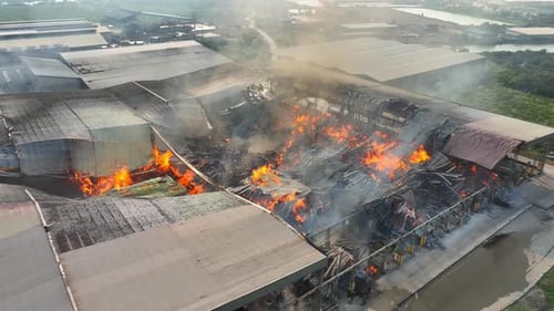 Aerial view captures a catastrophic fire at an industrial plant.