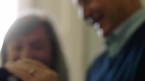 Close Up Happy Senior Couple Using Smart Phone and Laughing 6569 Years