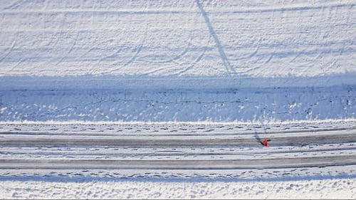 Male Runner Jogging on Winter Snowy Road