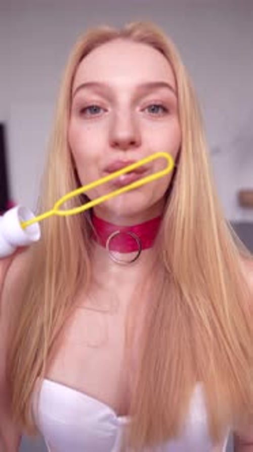 Young Woman Blowing Bubbles Close Up