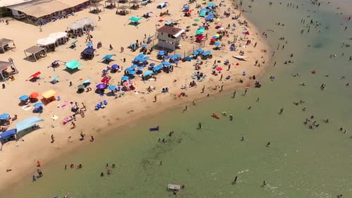 Beautiful sandy beach with people and colourful umbrellas