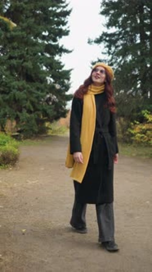 Beautiful Lady Walking Through Vibrant Garden Wearing Yellow Beret and Scarf Looking Around