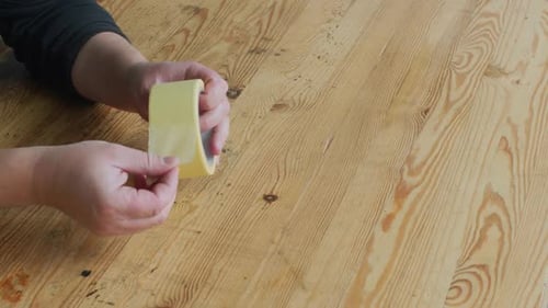 Hands Tearing Masking Tape on Wooden Table Close Up