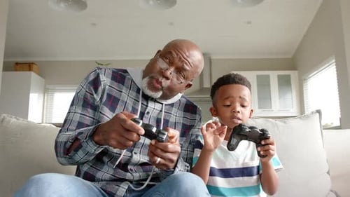 Grandfather and Grandson Play Video Game Together