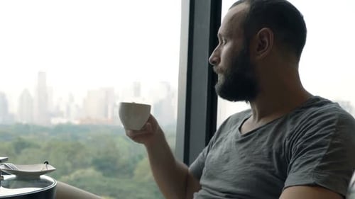 Young Man Relaxing, Drinking Coffee Sitting in Cafe 30s