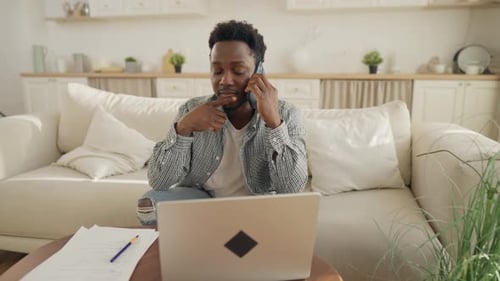 Young Adult Working from Home on Laptop