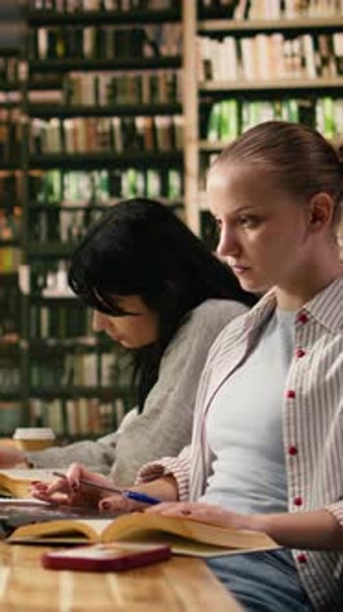 Vertical Video Student Uses Laptop and Book Losing Concentration When Mobile Message Appears