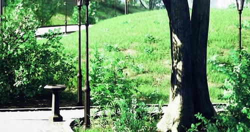 Vibrant Park Setting with Lush Greenery and Vintage Lamp Posts in Sunlight