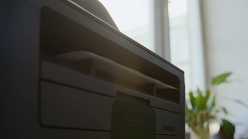 Hand of Black Male Office Worker Taking Document from Printer