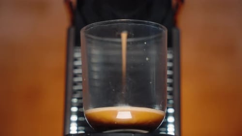 Espresso Machine Dispensing Coffee into Glass Cup