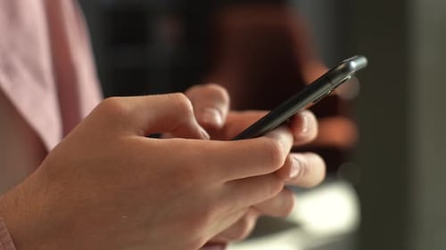 Closeup Side View of Hands Unrecognizable Man Using Mobile Phone Doing Swiping Scrolling Gestures