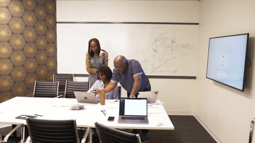 Coworkers Collaborate in a Modern Conference Room