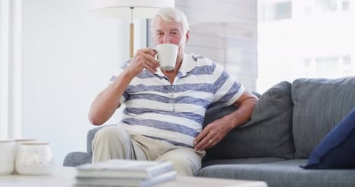 Senior Man Relaxing With Coffee Indoors