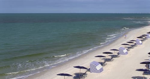 Beach Chairs and Tourists on Florida Beach, Aerial Drone Above