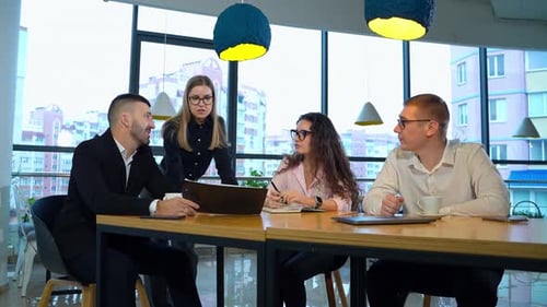 Business Meeting Around a Wooden Table in Office