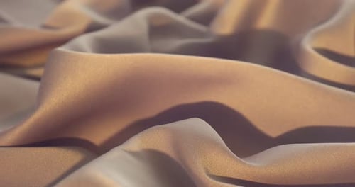 Crumpled beige silk fabric as background, closeup. Changing direction of light