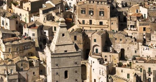 Closeup Of Matera Cathedral Tower With Matera City In Basilicata, Italy. - aerial shot