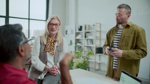 Diverse Coworkers Having Talk during Coffee Break in Modern Minimalist Office