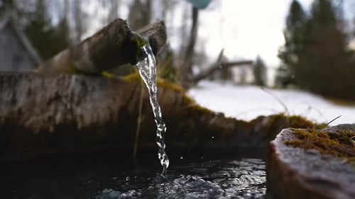 Clear Drinking Water Flows from a Spring in a Mountain Well