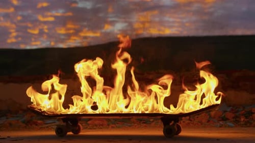 Burning Skateboard on Concrete at Sunset