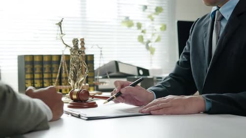 Lawyer and Client Handshake After Signing Agreement