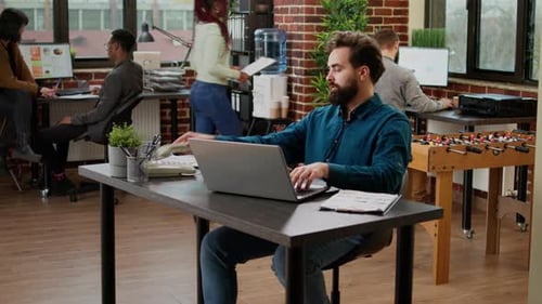 Project Manager Answering Landline Phone Call in Startup Office