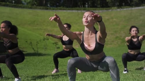 Women Working Out Together in a Grassy Park