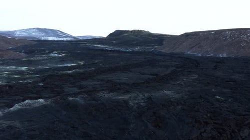 Vast dark black solidified lava field flowing downhill in Iceland, Fagradalsfjall