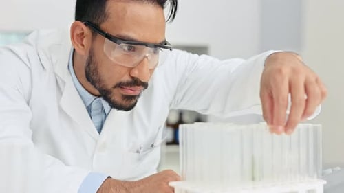 Scientist Inspecting Test Tubes in Laboratory