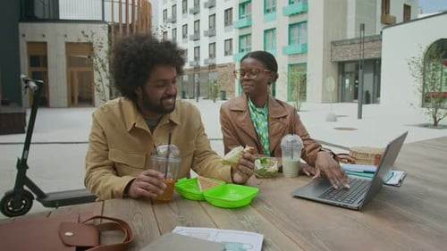 Young Adults Working on Laptop and Eating Lunch