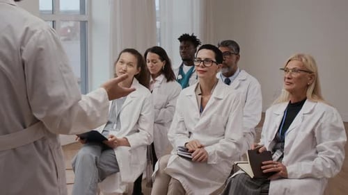 Medical Professionals Listening to Lecture in Bright Room