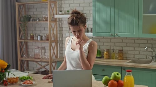 Young Woman at the Table in the Kitchen Preparing Spring Rolls for Healthy Lunch Woman Cutting