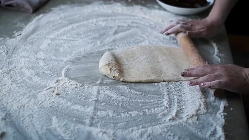 Rolling Dough with Chocolate Filling and Nuts