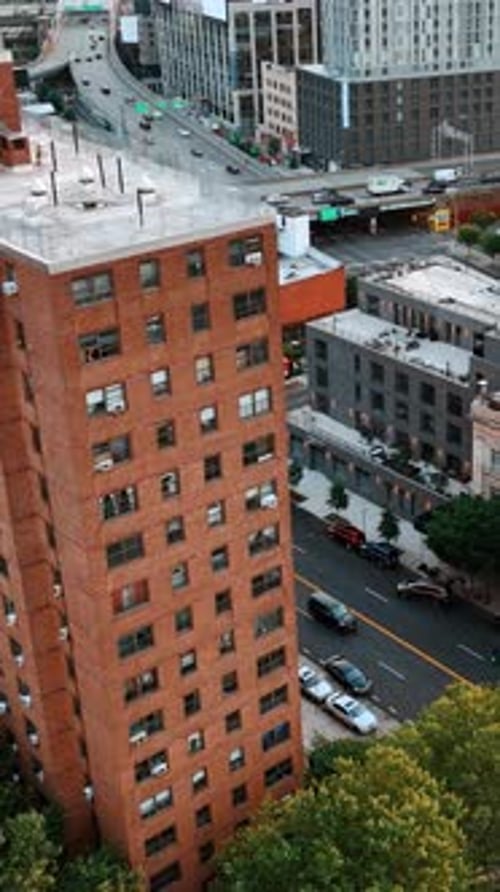 Urban landscape with blocks of flats and roads. Green areas on the tops of the houses.