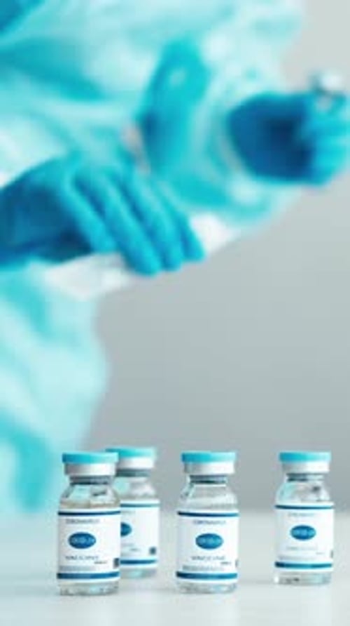 Vaccine Preparation by Medical Worker in Blue Suit