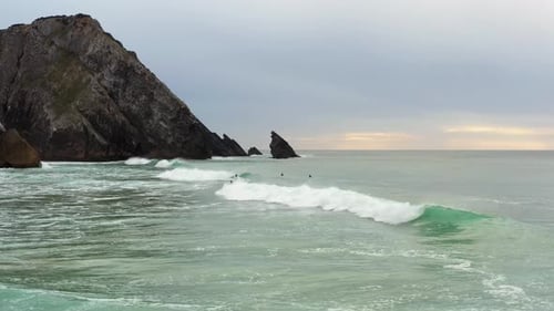 Bodyboarder Surfing Ocean Wave at Sunset