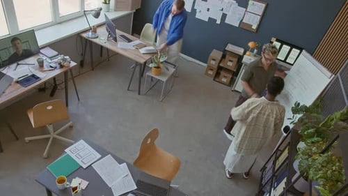 UX Designers Working on Mobile App then Discussing Plan at Flipchart in Office