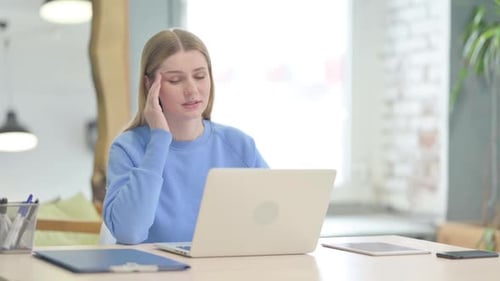 Young Adult Using Laptop With Headache