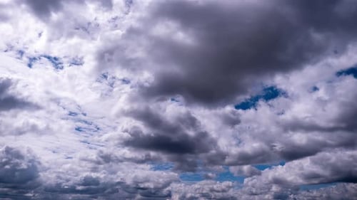 Dramatic Clouds Moving Across Bright Blue Sky