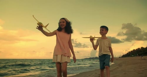 Happy Children Playing with Toy Airplanes Running on the Beach Little Children Brother and Sister