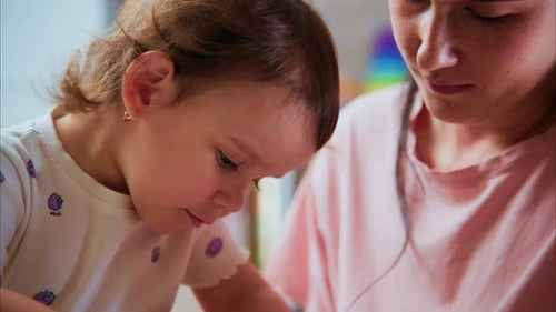 Adorable Toddler Plays with Clay with Adult Woman