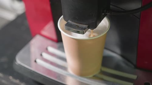 Coffee Machine Dispensing Coffee Into Disposable Cup