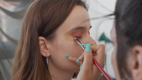 Makeup Artist Applying Makeup to Model's Face Close Up View