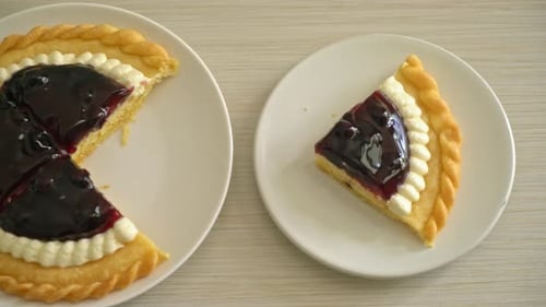 Delicious Blueberry Pie with Cream on White Plate
