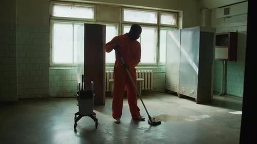 African American Prisoner Mopping Floor