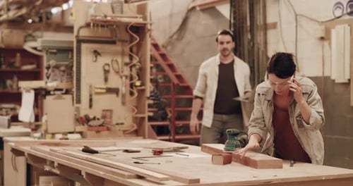 4k video footage of two young carpenters working in their woodworking workshop
