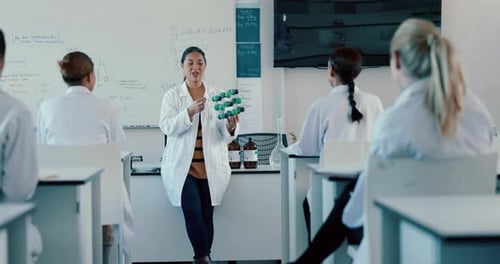 Teacher Explains Molecular Model to Science Students