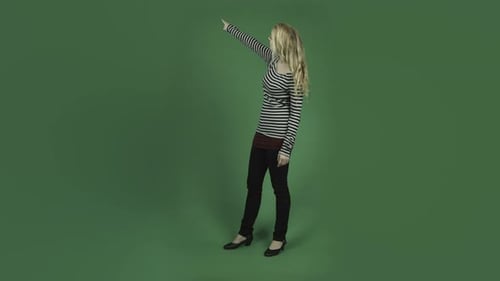caucasian woman isolated on chroma green screen background pointing smiling